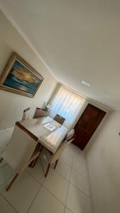 a room with a table and chairs and a window at Águas cristalinas 02 in Cabo Frio