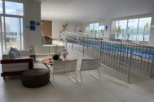 a living room with a swimming pool in a building at Walk Bueno, Próximo Parque Vaca Brava e Goiânia Shopping. in Goiânia