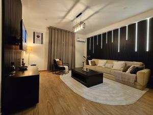 a living room with a couch and a table at Chez Ebène in Douala