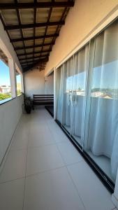 a balcony of a building with large windows at Águas cristalinas 02 in Cabo Frio