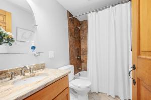 a bathroom with a toilet and a shower curtain at 57 Wood Avenue Sandwich - - Cape Cod in Sandwich +30 photos