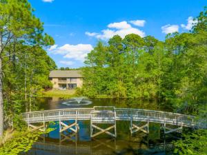 a bridge over a river with a house in the background at 30A - Cassine Station by Panhandle Getaways in Santa Rosa Beach