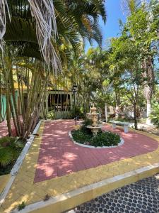 a brick walkway with a fountain in a park at Acomodações Hilton 100 in Ipueiras