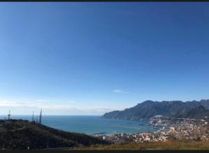 a view of a city and the ocean from a hill at Salerno BellaVista in Salerno