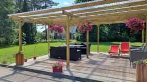 a pergola with a table and chairs on a patio at Krechowiak in Augustów