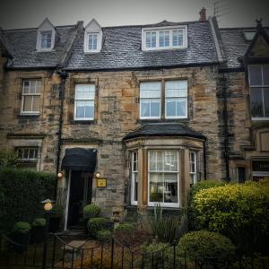 an old brick house with white windows at AmarAgua Guest house in Edinburgh