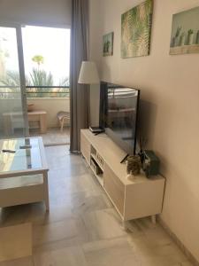 a living room with a fish tank and a table at Holidays beach Estepona in Estepona
