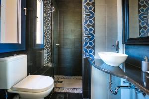 a bathroom with a white toilet and a sink at FMN Villas 1 in EFL +43 photos
