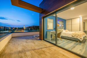 a bedroom with a bed and a view of the city at Villa ReMi mit 2 Whirlpools und Meerblick in Premantura +37 photos