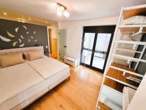 a bedroom with a bed and a book shelf at Anja's Ferienwohnung Europa Park in Ettenheim