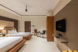 Postel nebo postele na pokoji v ubytování Anantharaa Hotel