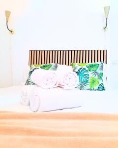 a bed with towels and pillows on it at Easy4Stay in Portimão