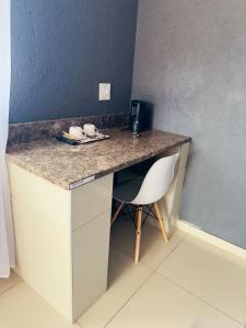 a desk with a chair in a room at Bakwena Lodge in Jane Furse
