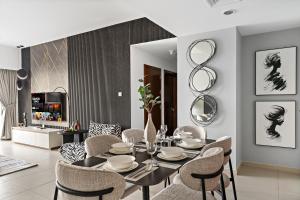 a dining room with a black table and chairs at Desert Key - Platinum Apartments in Gate Tower, Al Reem Island in Abu Dhabi +284 photos
