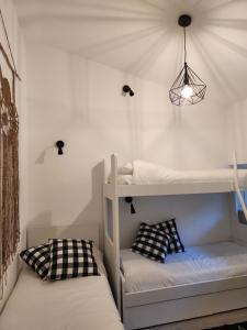 a room with two bunk beds and a lamp at L' Oliva Nera in Monte Isola