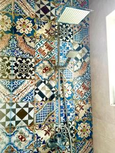 a bathroom with a tiled wall with a sink at Spacious two bedroom apartment with free parking in Dobrota +28 photos