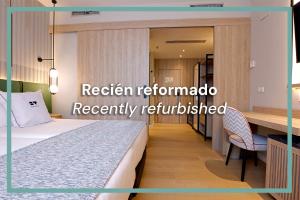 a hotel room with a bed and a desk at Hotel & Spa Villa Olimpica Suites in Barcelona