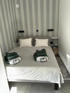 - un lit avec 2 serviettes vertes dans l'établissement Studio apartman Mango, à Jadranovo