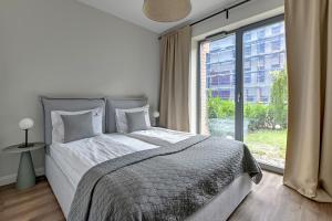 Giường trong phòng chung tại Scala City Center Apartments by Lion Apartments