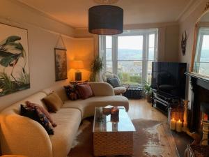 a living room with a couch and a tv at Dolgellau Townhouse 2 Minutes to Town & Mountains in Dolgellau