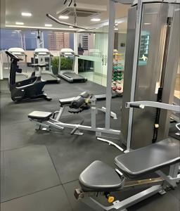 a gym with several treadmills and machines at Flat Luxo Boa Viagem Perto da Praia e Shopping Recife in Recife