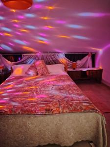a bedroom with a large bed with a purple ceiling at Casa di Francesca in Ruvo del Monte