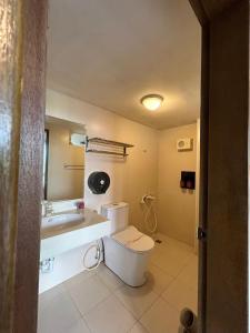 a bathroom with a toilet and a sink at Miaoli Sanyi Travelling Homestay in Sanyi