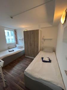 a small room with a bed and a window at 2-Rent Group Hostel Apartments SEN14 in Munich