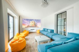 a living room with blue couches and orange pillows at Chalupa Libverda in Lázně Libverda