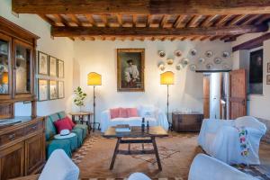 a living room with blue couches and a table at Villa Deda 12&2 by Marche Holiday Villas in Saltara