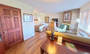 a living room with a couch and a bed at Arbors at Island Landing Hotel & Suites in Pigeon Forge