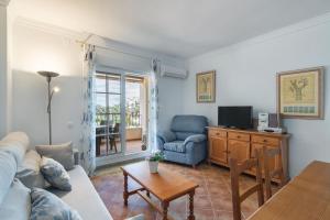 a living room with a couch and a table at Playa Grande - Playa Punta del Moral PPHG88P84 in Punta del moral