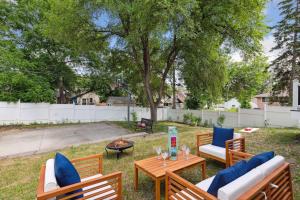 a backyard with a table and chairs and a fire pit at Basketball Court, Pickleball, Karaoke, 6 Beds in Minneapolis