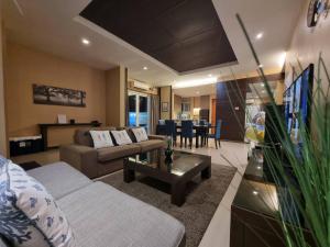 a living room with a couch and a table at Sea Life Poolville in Jomtien Beach