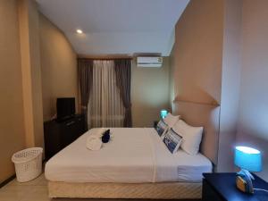 a bedroom with a bed with a cat sitting on it at Sea Life Poolville in Jomtien Beach +51 photos