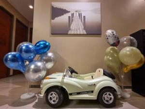 a toy car and balloons on a table at Sea Life Poolville in Jomtien Beach
