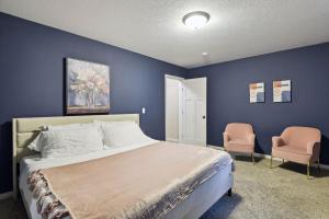 a blue bedroom with a bed and two chairs at Basketball Court, Pickleball, Karaoke, 6 Beds in Minneapolis