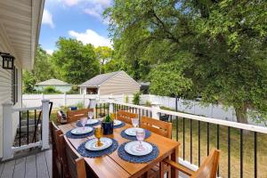 a wooden table on a deck with a fence at Basketball Court, Pickleball, Karaoke, 6 Beds in Minneapolis
