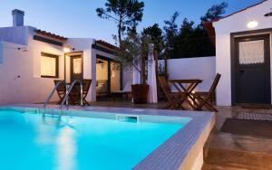 a swimming pool in front of a house at Casas da Praia - Casas da Amieira in Amieira