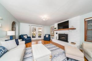 a living room with a couch and a fireplace at 5 Bedroom with Fire Pit, Patio & Large Yard in South Haven