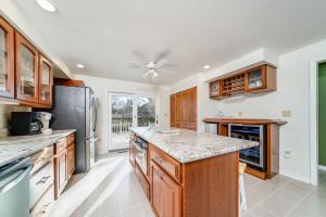 a kitchen with wooden cabinets and granite counter tops at 5 Bedroom with Fire Pit, Patio & Large Yard in South Haven