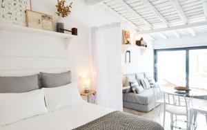 a white bedroom with a bed and a living room at Casas da Praia - Casas da Amieira in Amieira +38 photos