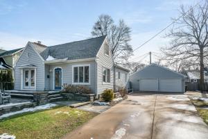 a white house with a driveway at 5 Bedroom with Fire Pit, Patio & Large Yard in South Haven