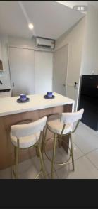 a kitchen with two stools and a counter in a room at Skytrees 公寓 距Aeon五分钟路程 in Johor Bahru