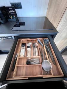 a drawer filled with utensils in a kitchen at Exclusive Wellness House with Jacuzzi and Sauna, 10 Gardens in Privlaka