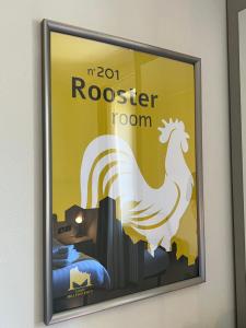 a poster of a rooster on a wall at Casale Milleseicento in Gavi