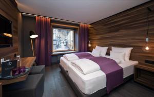 Säng eller sängar i ett rum på Stadthotel Brunner
