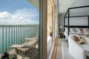 a bedroom with a view of the water at 3 Bedroom Luxury Waterside House in Hayle