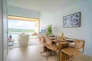 a dining room with a table and chairs and a large window at 3 Bedroom Luxury Waterside House in Hayle