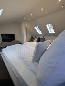 a large white bed in a room with skylights at Himmel Suite in Schönau an der Brend